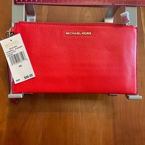 Michael Kors large zip clutch; genuine leather; dark sangr